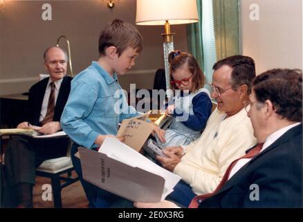 Bethesda, Maryland - May 5, 1991 -- United States President George H.W. Bush was greeted by two of his grandchildren, Sam and Ellie LeBlond in the Presidential Suite at Bethesda Naval Hospital in Bethesda, Maryland on May 5, 1991. The President was meeting with Chief of Staff John Sununu, right, and National Security Advisor Brent Scowcroft, left. Sam and Ellie are the children of the President's daughter, Dorothy.Photo by RWhite House/CNP/ABACAPRESS.COM Stock Photo