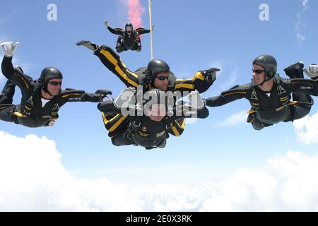 Former United States President George H.W. Bush jumps with the United States Army Golden Knights Parachute Team at the Bush Presidential Library near Houston, Texas on June 13, 2004 to celebrate his his 80th birthday. His jump was witnessed by 4,000 people including Actor and martial-arts expert Chuck Norris and Fox News Washington commentator Brit Hume. Both also participated in celebrity tandem jumps as part of the event. Bush made the jump harnessed to Staff Sergeant Bryan Schell of the Golden Knights. Bush was reportedly contemplating a free-fall jump, but officials said the wind condition Stock Photo