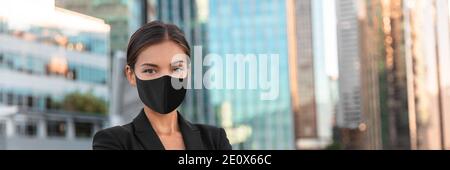 Woman wearing face mask at office work during coronavirus. Asian businesswoman portrait banner panoramic Stock Photo