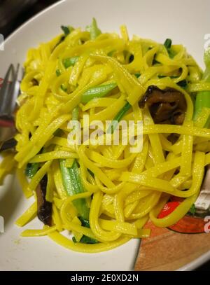 Vegan stir fry egg noodles with vegetables, paprika, mushrooms, chives ...