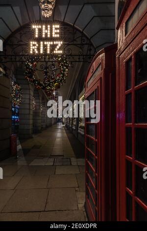 The Ritz Hotel and iconic red telephone boxes in London during the lockdown and festive season. Stock Photo