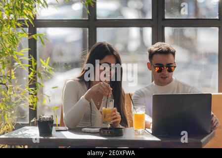 Co-workers spending time together on a break while working on a project on a lovely sunny day. Stock Photo