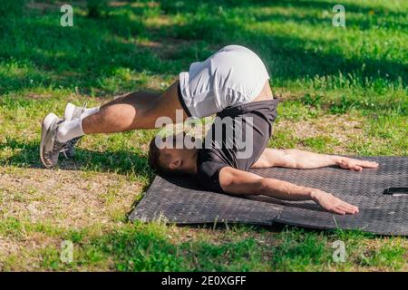 Premium Photo  Young fit male practicing yoga and doing the balancing  stick pose outdoors
