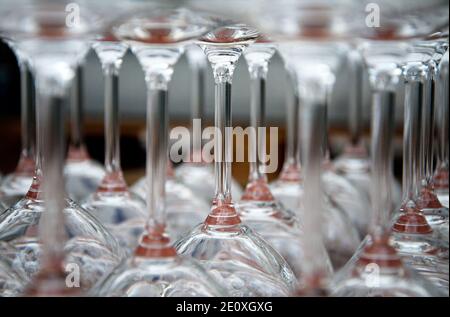 Empty clean crystal wine glasses inverted on the table. Reflections in the glass. Stock Photo