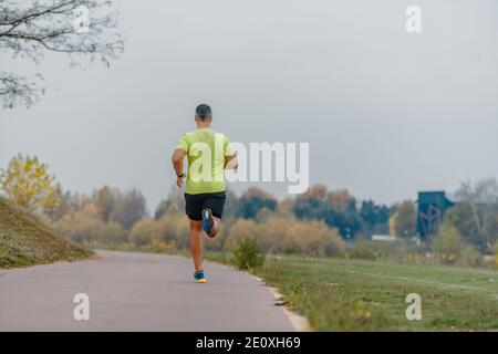 Well built middle aged athlete during a running exercise Stock Photo