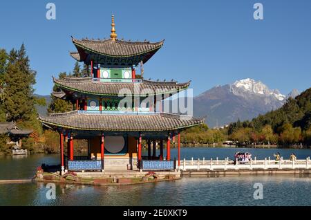 Pagoda on Black Dragon lake with Black Dragon Mountain in the distance, Lijiang, Yunnan province, China Nov 2020 Stock Photo