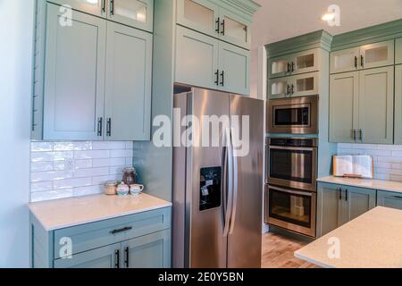 Modern electric cooking appliances and built in cabinets inside kitchen of home Stock Photo