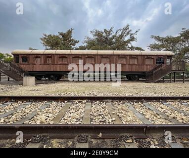 a luxurious historic lounge car from the ottoman and world war one periods with narrow gauge train tracks in the foreground and a grey sky in the back Stock Photo