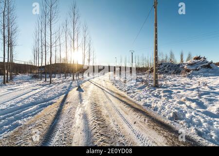 Winter snowy road on a sunny day after the snowplow. Stock Photo