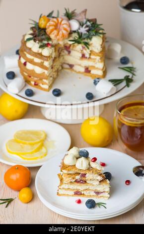 Honey cake pieces on a plate with lemon tea for dessert. Stock Photo