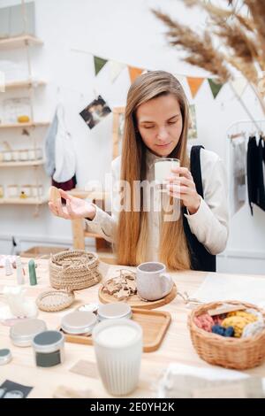 Woman in an ecological shop choosing between various cosmetic products. Stock Photo