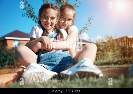 Two happy girls friends in nature. Friendly hugs of teenage girls Stock Photo