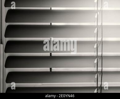 Close-up of horizontal blinds in a half-open state. In sepia tones. Stock Photo