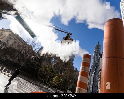 New York City, NY (USA) - 16 November 2019: Steam vapor is raising from the New York City steam systems at a corner of Broadway, NYC. Stock Photo