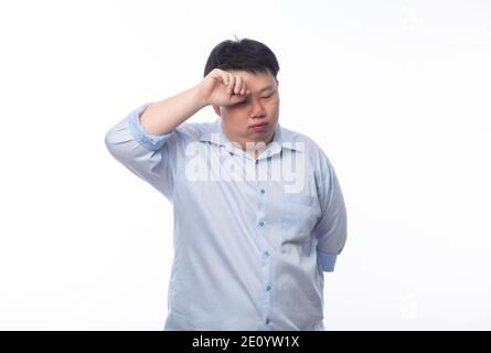 Young Fat Asian business man feeling sad with unhappy face isolated on white background. Stock Photo