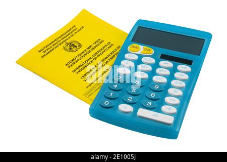 Certificate of vaccination and calculator isolated on white background Stock Photo