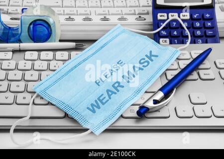 Please Wear Mask Please and office background with PC keyboard Stock Photo