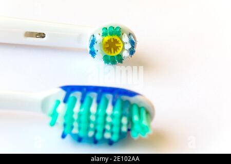 Electric and traditional toothbrushes in close-up. Toothbrush head without paste. Stock Photo