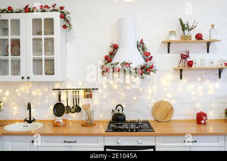 winter kitchen with red decorations, christmas cooking table and utensils Stock Photo