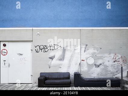 Old rotten sofa in front of a building Stock Photo