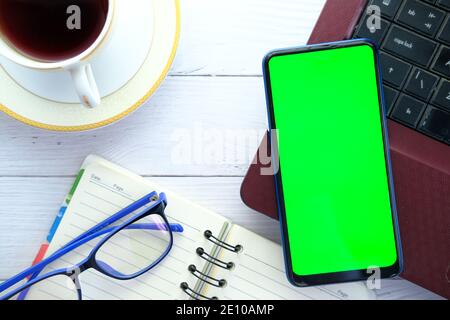 top view of smart phone, laptop and notepad on table  Stock Photo