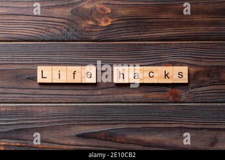 life hacks word written on wood block. life hacks text on table, concept. Stock Photo