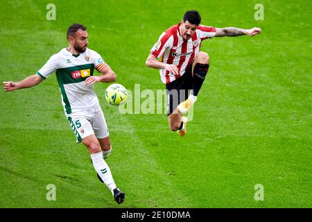 Bilbao, Spain. January, 2021. Yuri Berchiche of Athletic Club duels for the ball with Gonzalo Verdu  of Elche C.F during the La Liga match between Athletic Club Bilbao vs Elche CF played at San Mames Stadium. Credit: Ion Alcoba/Capturasport/Alamy Live News Stock Photo