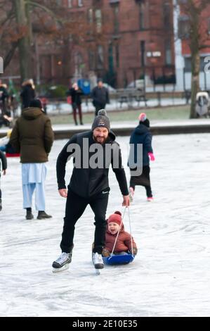 Glasgow, Scotland, UK. 3rd January, 2021. UK Weather: Skating and Ice Hockey on the frozen pond at Queen's Park. Credit: Skully/Alamy Live News Stock Photo