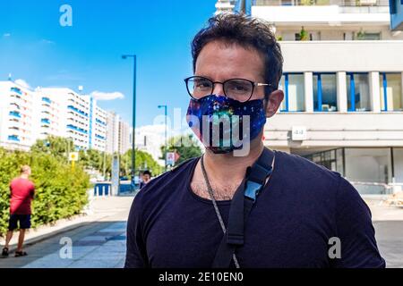 Berlin, Germany. Mature gay male shopping for groceries inside a local supermarket wearing a 'protective' facemask due to Corona Outbreak. In Germany Stock Photo