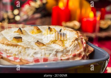 French camembert cheese baked in the oven with garlic Stock Photo