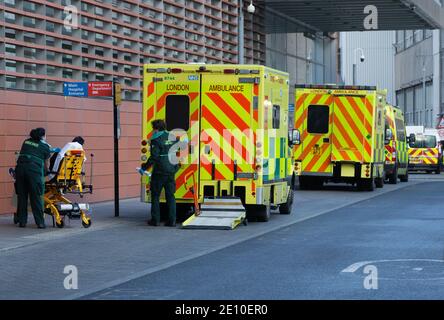 London, UK. 3rd Jan, 2020. A patient arrives at the hospital. Ambulances parked outside The Royal London Hospital in Whitechapel. The NHS is under severe pressure as the pandemic reaches a record daily number of positive cases of Covid-19. Credit: Mark Thomas/Alamy Live News Stock Photo