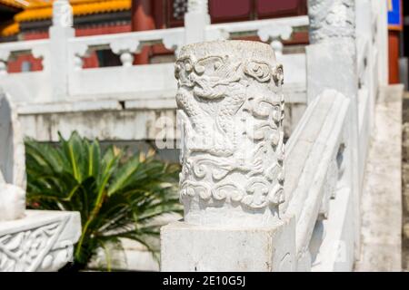 Chinese traditional culture, ancient Chinese marble guardrail with ornamental dragon carving, ornamental column in front of new yuan ming palace, Zhuh Stock Photo