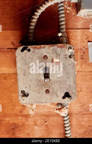 Electrical Switch in in Off Mode, Set in Metal Junction Box on Wooden Surface with BX Cable Stock Photo