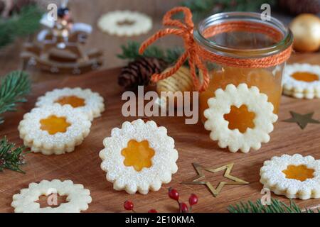 christmas biscuits Spitzbuben with apricot jam on wooden board Stock Photo