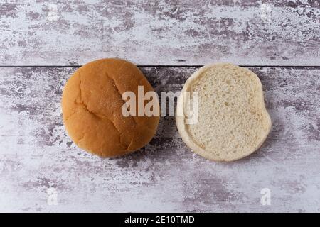 A view of a white burger bun split in half placed side by side and viewed from above Stock Photo