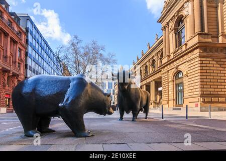 Place in front of the entrance to the Frankfurt Stock Exchange. Bull and bear as a symbol figure. Commercial buildings with a brown facade in the suns Stock Photo