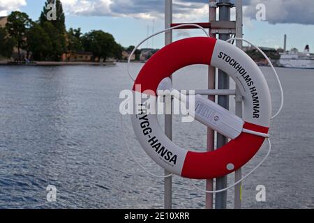 Stockholm, Sweden - July 12, 2020: Swedish sea safety with life-buoy in the foreground at the harbor of Stockholm Stock Photo