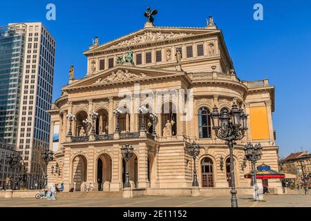 Old Frankfurt Opera in the city center. Historic building in springtime in sunshine. Street lights with space in front of the building. Business build Stock Photo