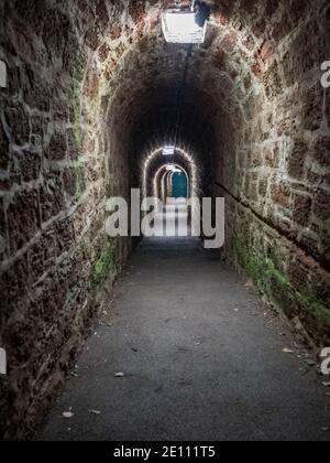 Walking through the Smuggler's Tunnel to Ness Beach in Shaldon, Devon, England, UK Stock Photo