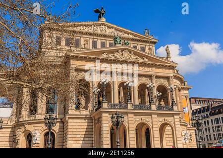 Historic building of the old opera house in Frankfurt in springtime with sunshine. Public square with trees in the center of the city with commercial Stock Photo