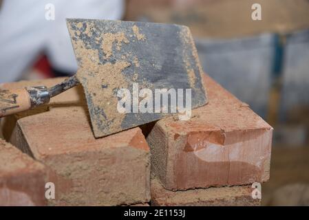 Trowel And Small Bricks - Close-up Of Smoothing Trowel Stock Photo