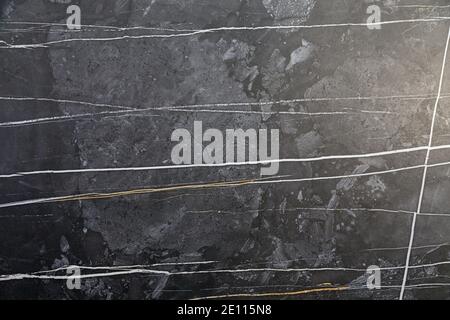 Artificial stone backdrop is similar to natural. It can look like onyx or marble or granite or any other black stone. Close-up. Stock Photo