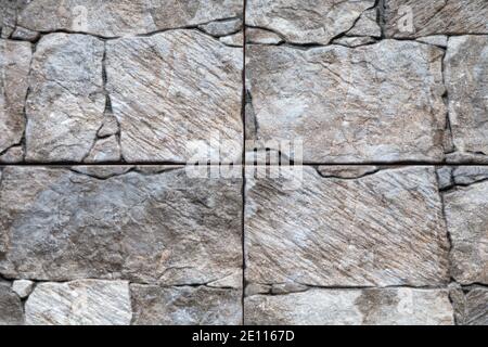 Artificial stone backdrop is similar to natural. It can look like onyx or marble or granite or any other black stone. Close-up. Stock Photo