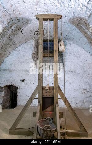 Ancient guillotine in the basement of the castle. Tool to apply the death penalty: the guillotine Stock Photo