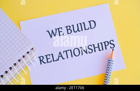 WE BUILD RELATIONSHIPS written on white paper. Business photo showcasing initiate good working relationships with others Stock Photo