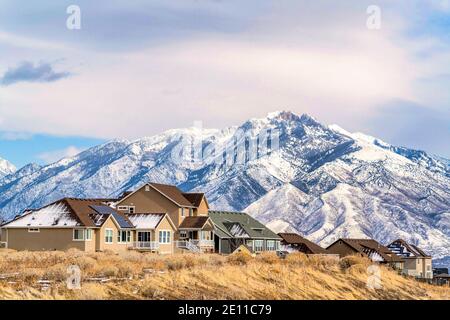 Homes with solar panels on roof against magnificent snowy Wasatch Mountain view Stock Photo