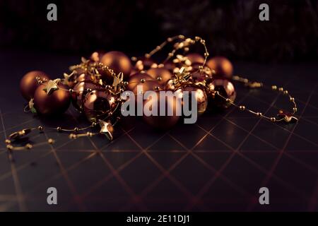 Christmas Tree Balls In Bronze And Gold With Golden Star Chain On Dark Background With Golden Rhombuses Stock Photo