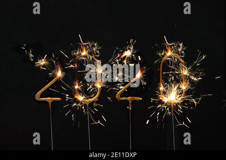 Goodbye 2020. Happy New Year! Sparklers decoration on dark background Stock Photo