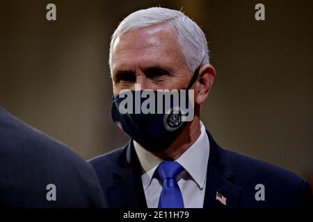 Washington, DC, USA. 3rd Jan, 2021. United States Vice President Mike Pence, wears a protective mask while attending a swearing-in ceremony at the U.S. Capitol in Washington, DC, U.S., on Sunday, Jan. 3, 2021. The 117th Congress begins today with the election of the speaker of the House and administration of the oath of office for lawmakers in both chambers, procedures that will be modified to account for Covid-19 precautions. Credit: Samuel Corum/Pool via CNP | usage worldwide Credit: dpa/Alamy Live News Stock Photo