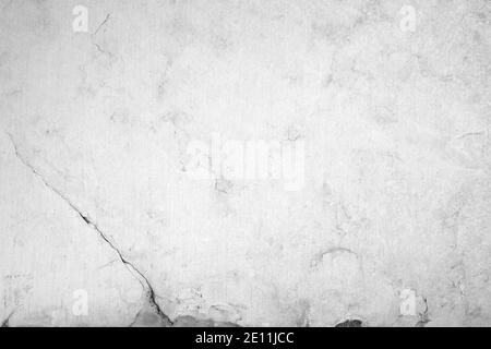 Close-up of an aged and cracked smooth natural marble stone wall or flooring. High resolution full frame textured background in black and white. Stock Photo